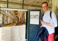 organ scholar with poster