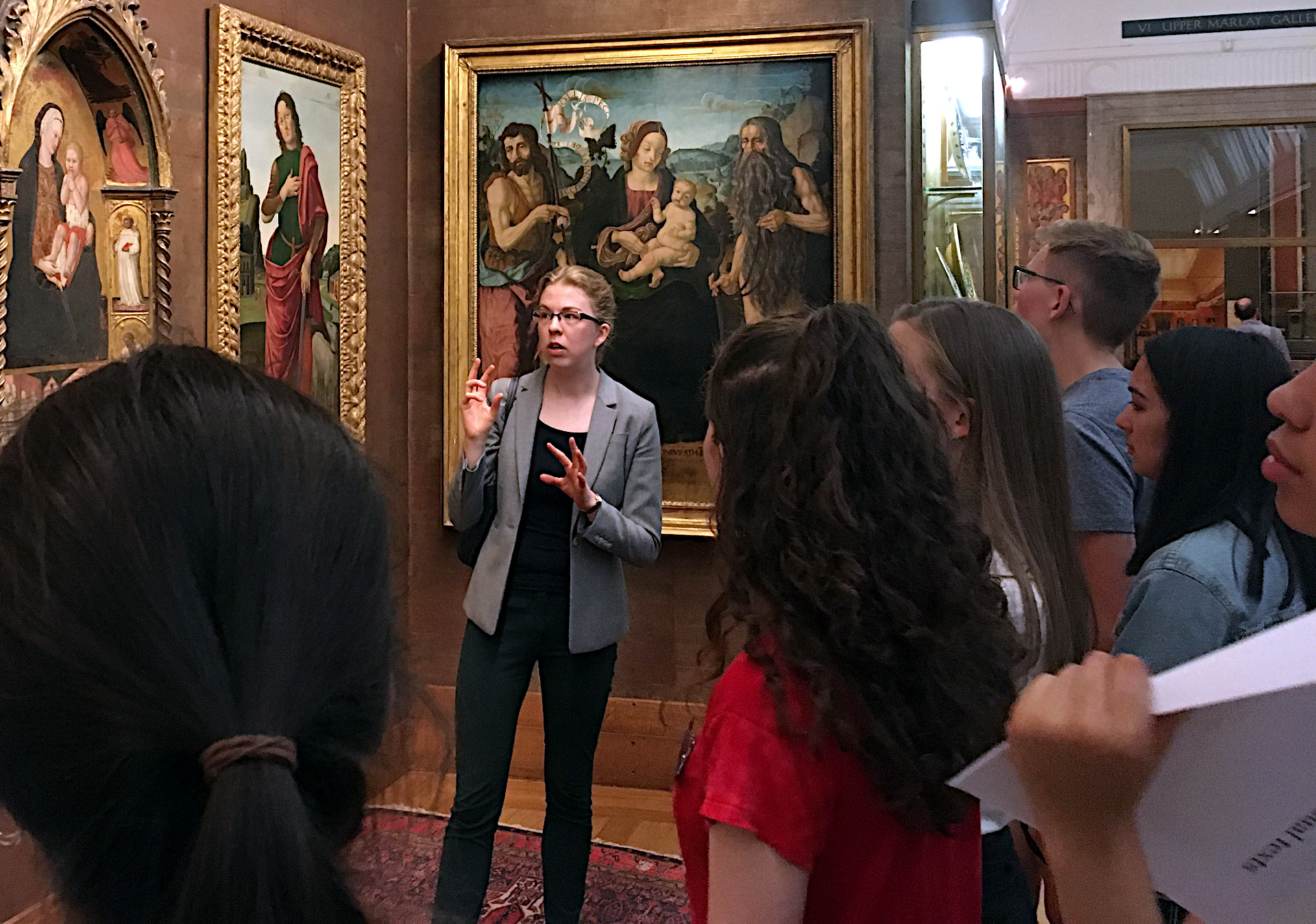 Our former fellow Dr Helena Phillips-Robins and students discussing Italian paintings in the Fitzwilliam Museum